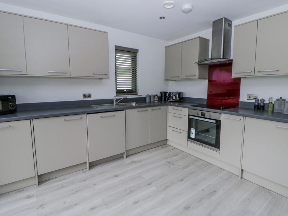 A kitchen with cabinets and appliances at Oak Lodge in Knighton