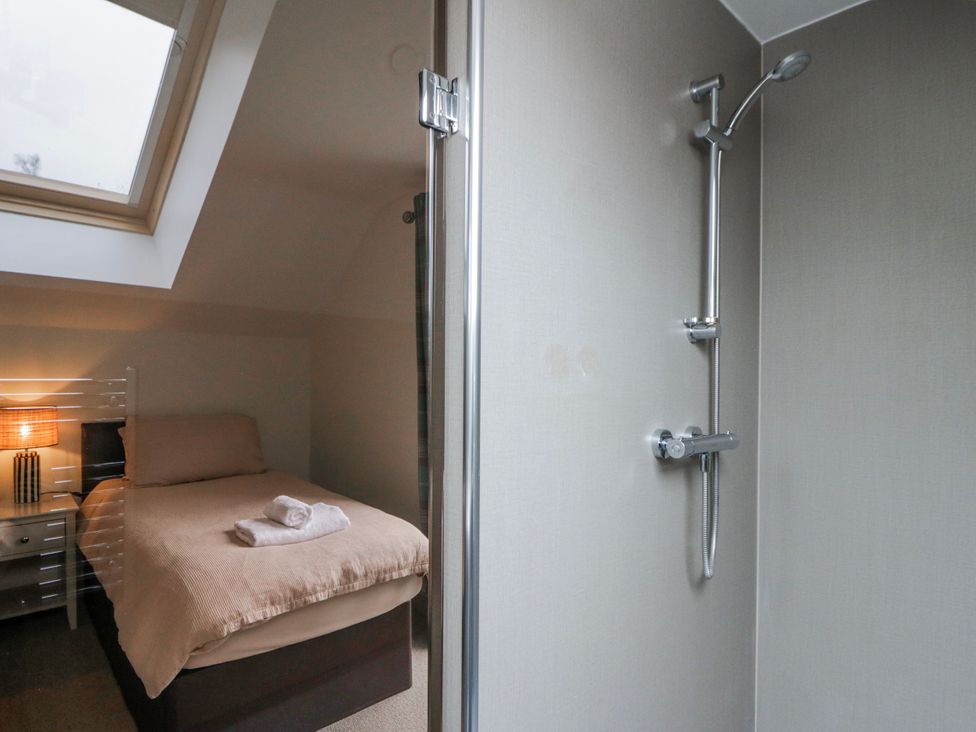 A bedroom with a bed and shower area at Oak Lodge in Knighton
