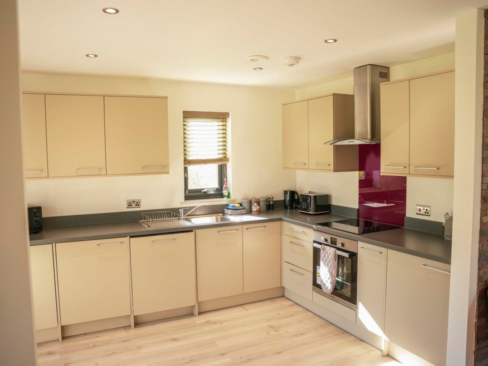 A kitchen with cabinets and appliances at Oak Lodge in Llangunllo