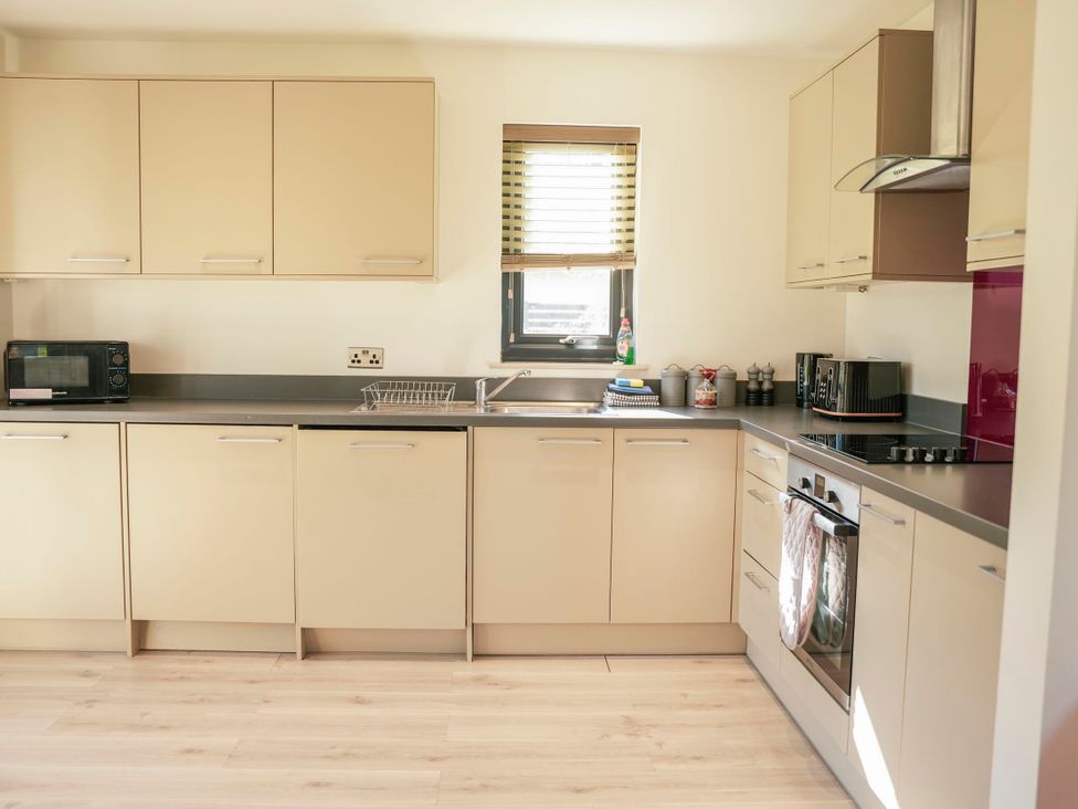A kitchen with cabinets and appliances at Oak Lodge in Llangunllo