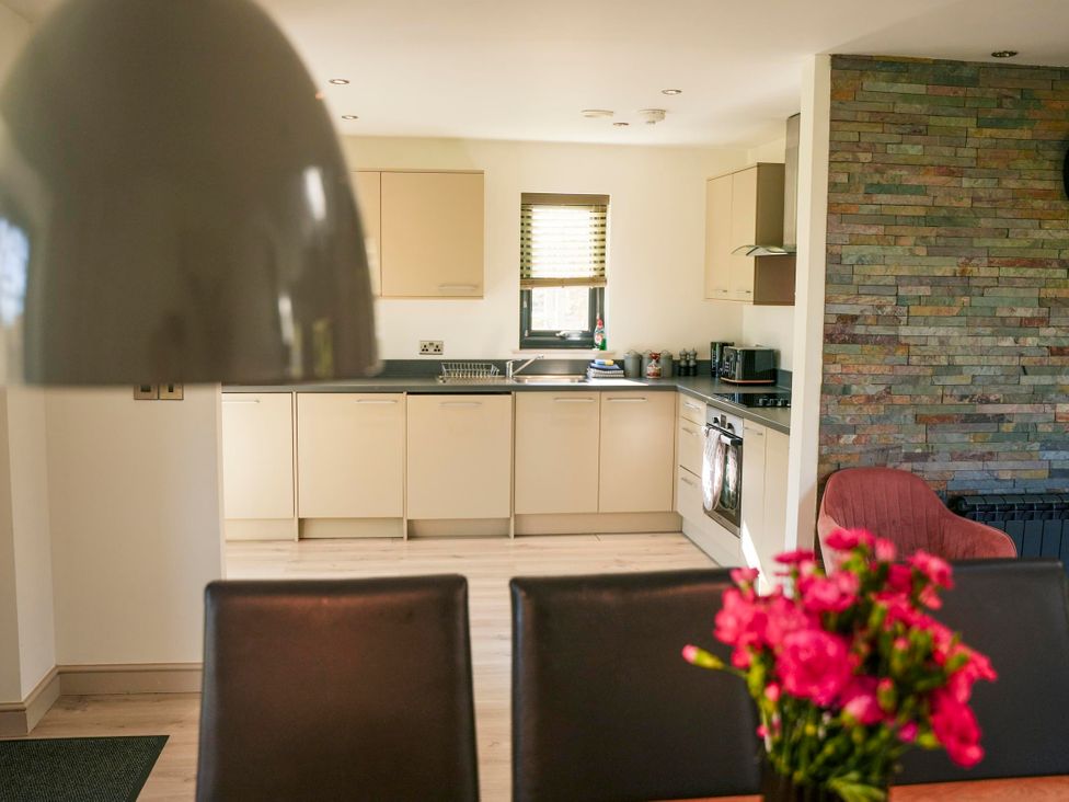 A kitchen with cabinets and a stove at Oak Lodge in Llangunllo