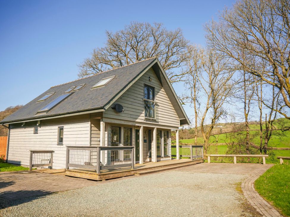 A house with a deck and trees at Oak Lodge in Llangunllo