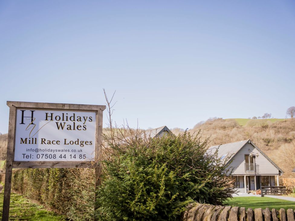 A sign for Mill Race Lodges at Holidays Wales in Llangunllo