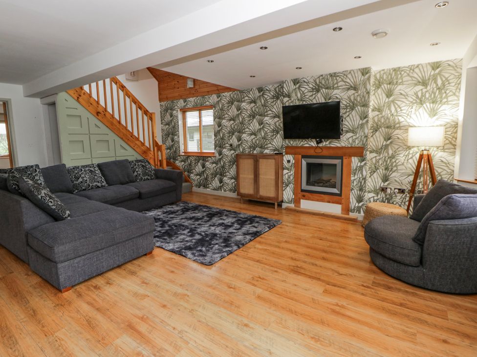 A living room with a sofa and a television at Willow Lodge in Knighton
