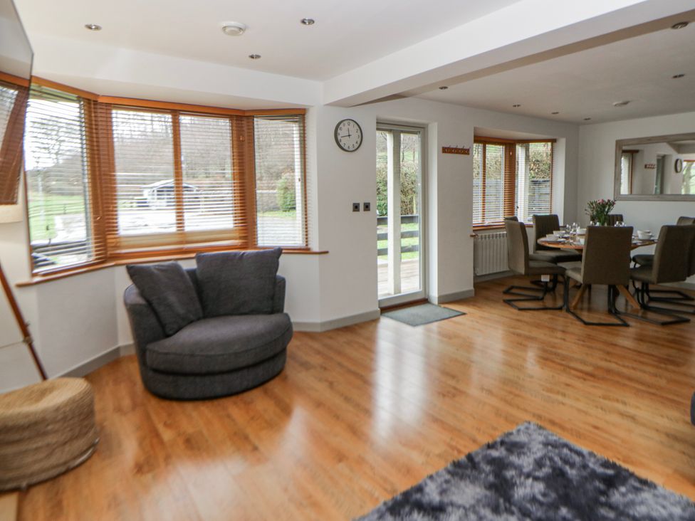 A living room with a sofa and dining area at Willow Lodge in Knighton