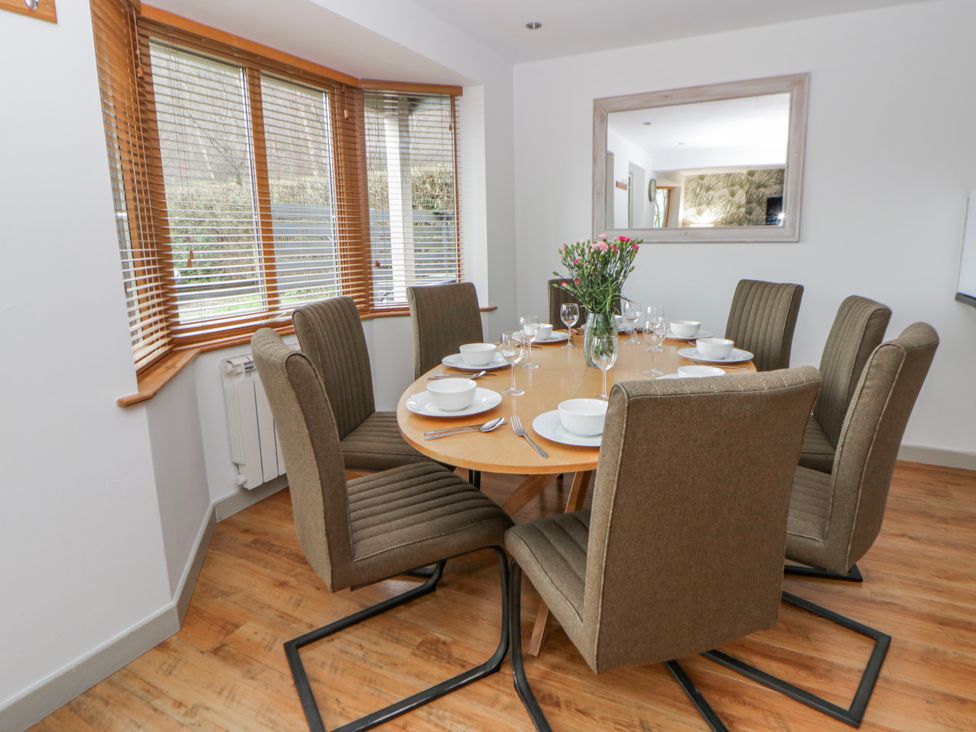 A dining room with a round table set for dinner at Willow Lodge in Knighton
