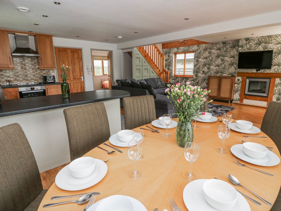 A dining room with a table set for dinner at Willow Lodge in Knighton