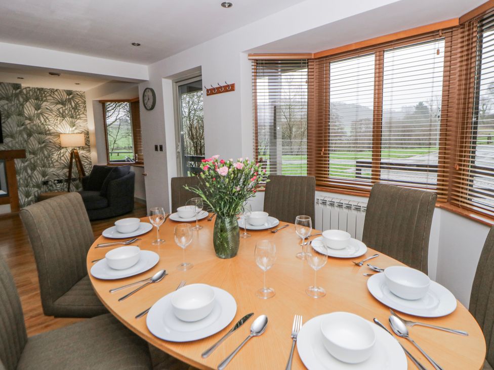 A dining room with a large table set for dinner at Willow Lodge in Knighton