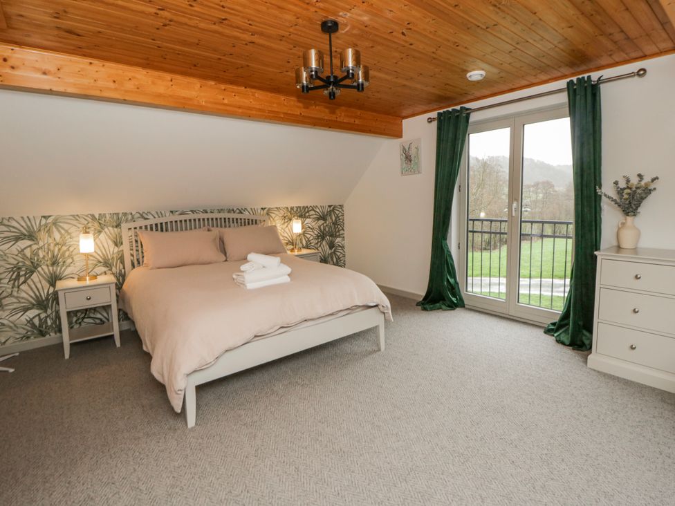 A bedroom with a bed and dresser at Willow Lodge in Knighton