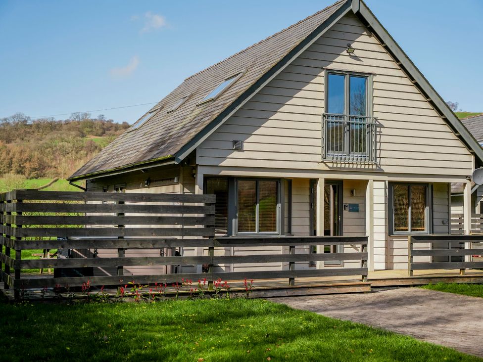 A house with a balcony and fence at Willow Lodge in Laceby