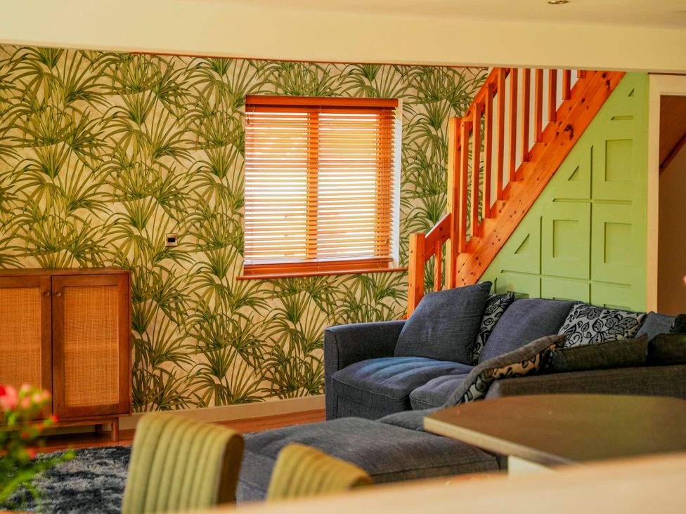 A living room with a sofa and window at Willow Lodge in Laceby