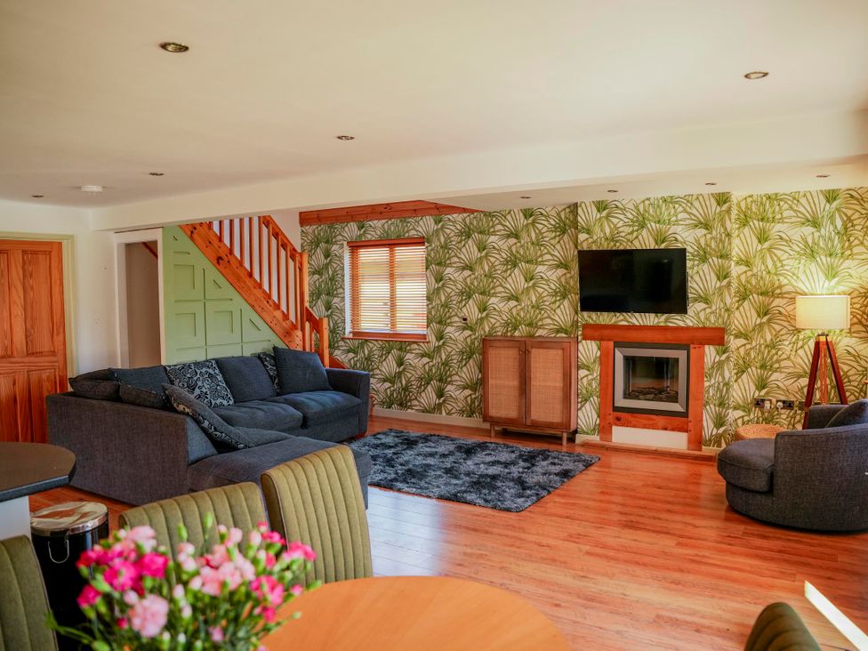 A living room with a sofa and fireplace at Willow Lodge Laceby