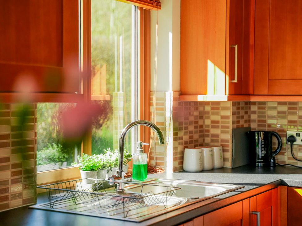 A kitchen with a sink and cabinets at Willow Lodge in Laceby