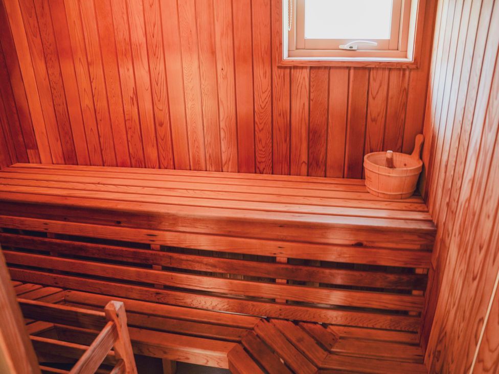 A sauna with wooden benches and a window at Willow Lodge in Laceby