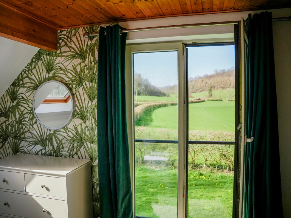 A bedroom with a view of greenery at Willow Lodge in Laceby
