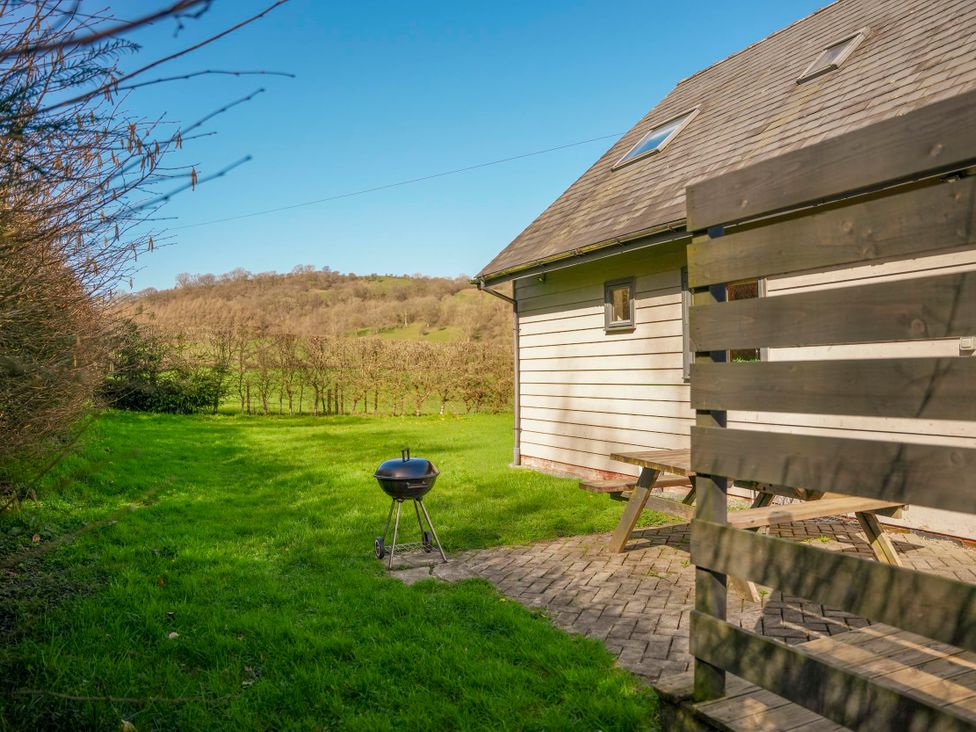 An outdoor space with a grill and seating area at Willow Lodge Laceby