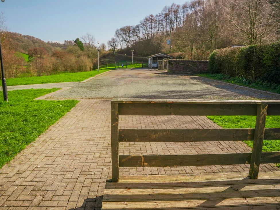 A view of a pathway and a bench in a grassy area at Willow Lodge Laceby