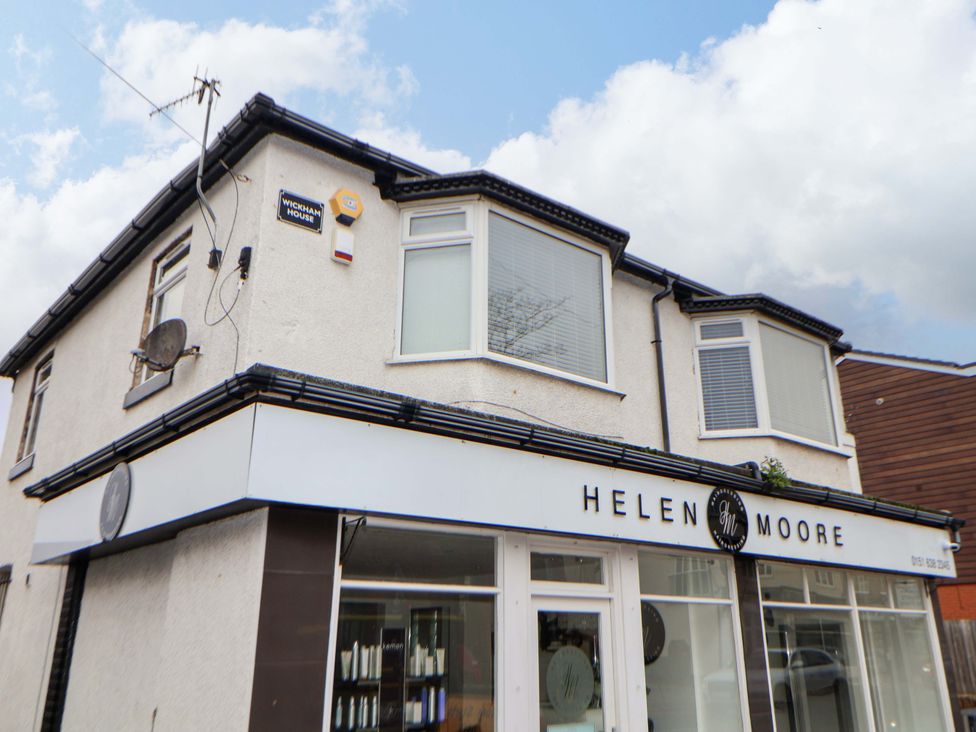 A building exterior with a sign and windows at Wallasey Village Escape by the Sea in Wallasey