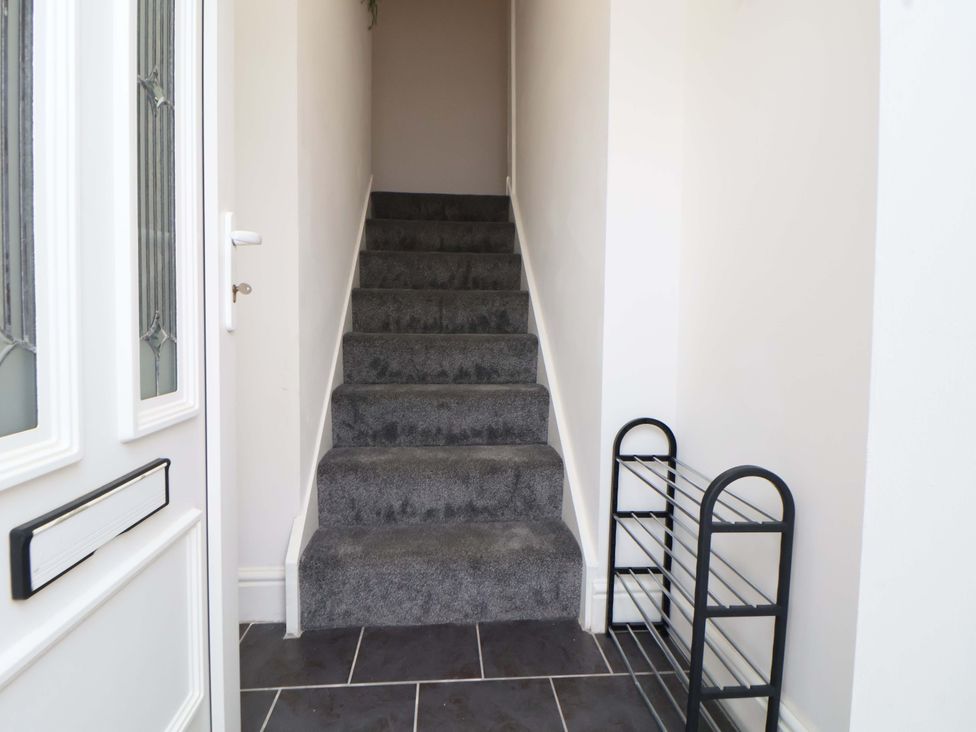 A hallway with stairs and a door at Wallasey Village Escape by the Sea, Wallasey