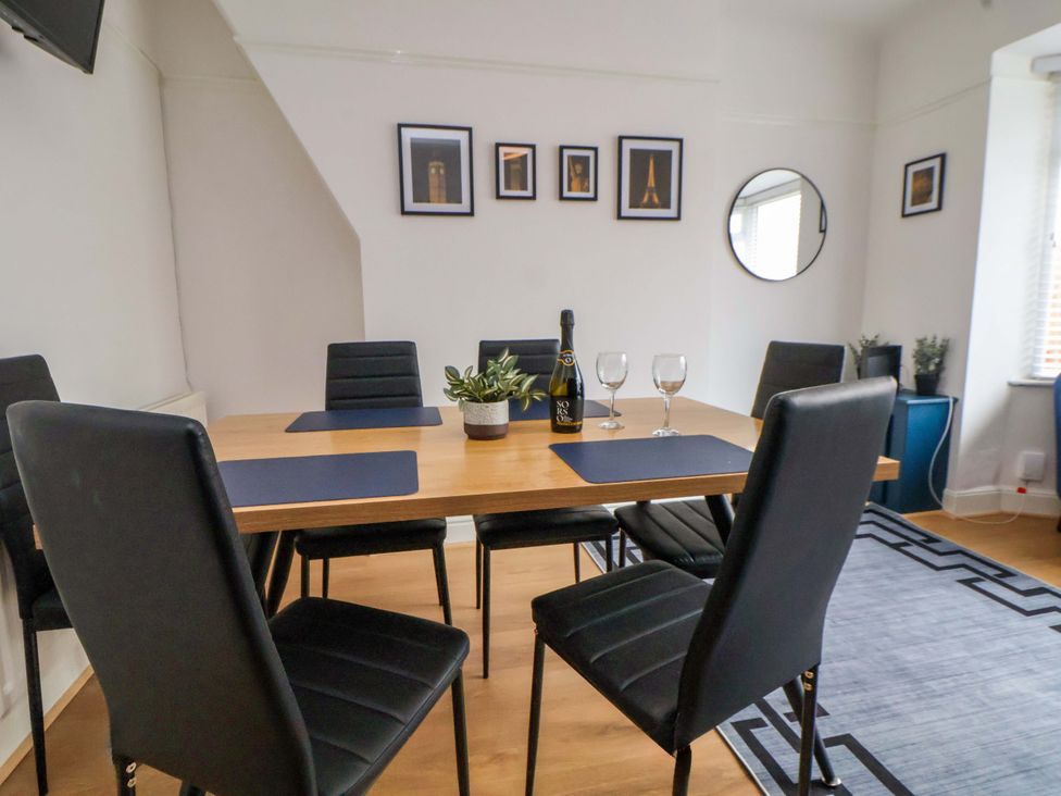 A dining room with a table set for drinks at Wallasey Village Escape by the Sea Wallasey