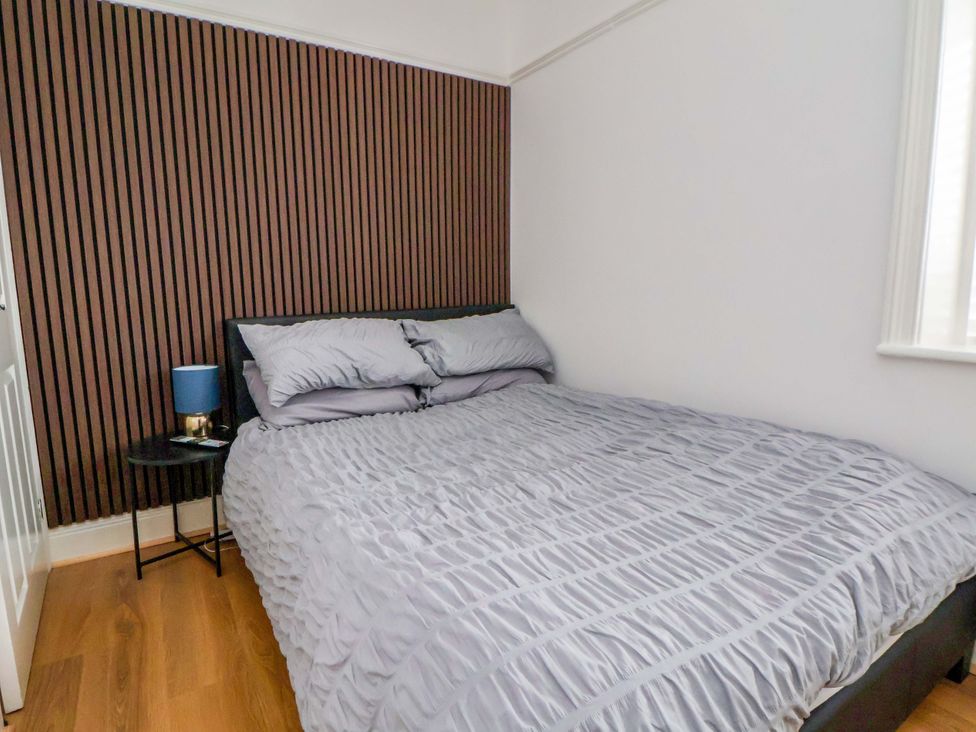 A bedroom with a bed and bedside table at Wallasey Village Escape by the Sea Wallasey