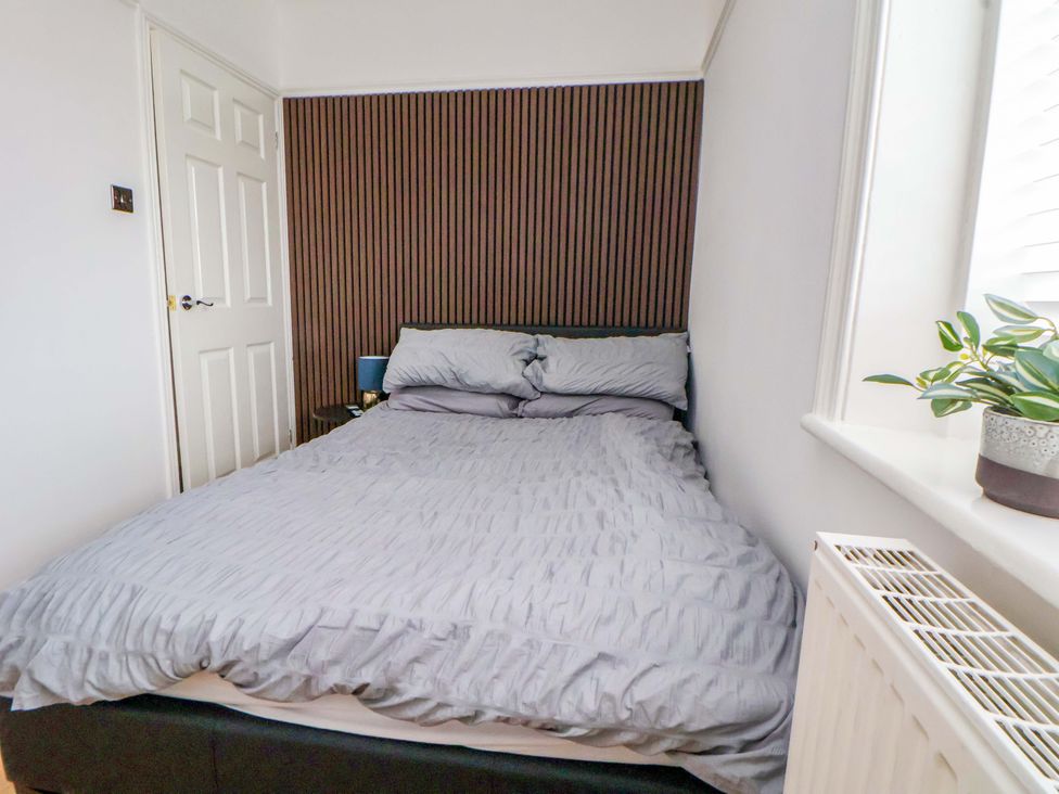 A bedroom with a bed and plant at Wallasey Village Escape by the Sea Wallasey