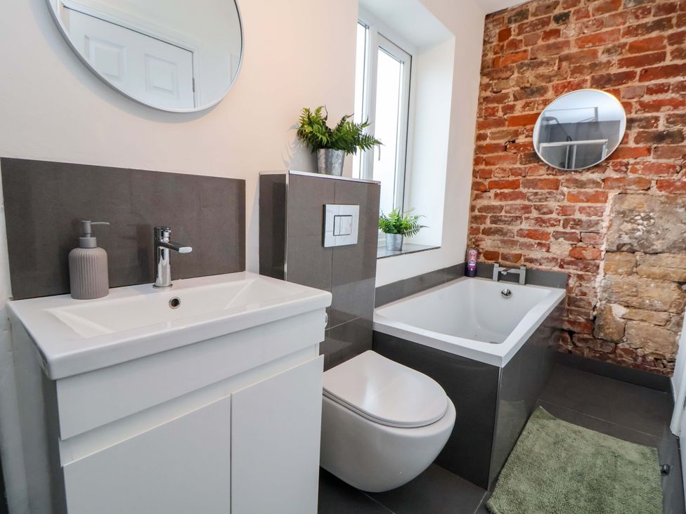A bathroom with a sink toilet and bathtub at Wallasey Village Escape by the Sea in Wallasey