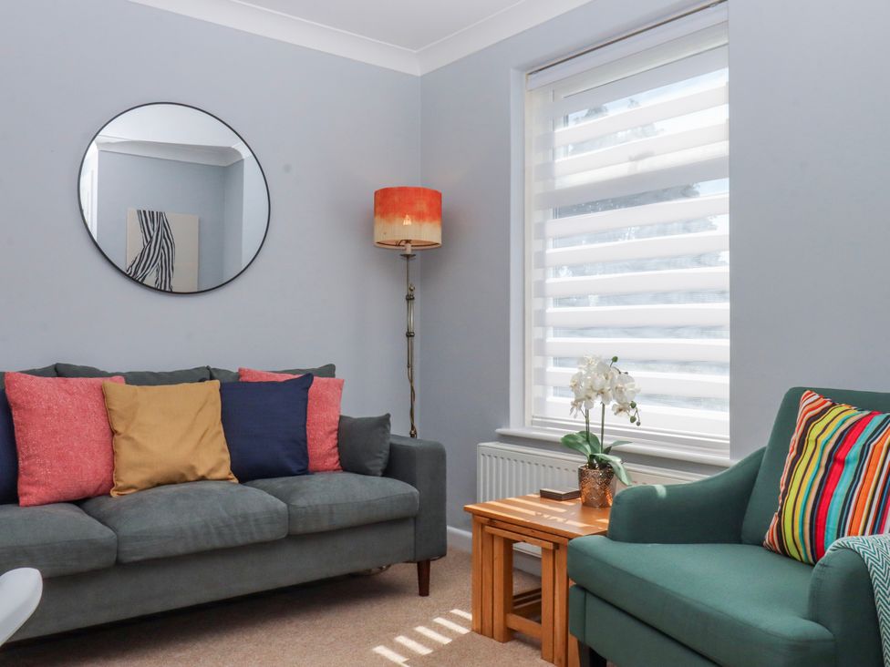 A living room with a sofa and coffee table at The Arches in Torquay