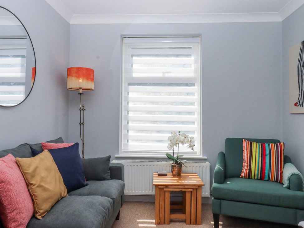 A living room with a sofa and chair at The Arches in Torquay