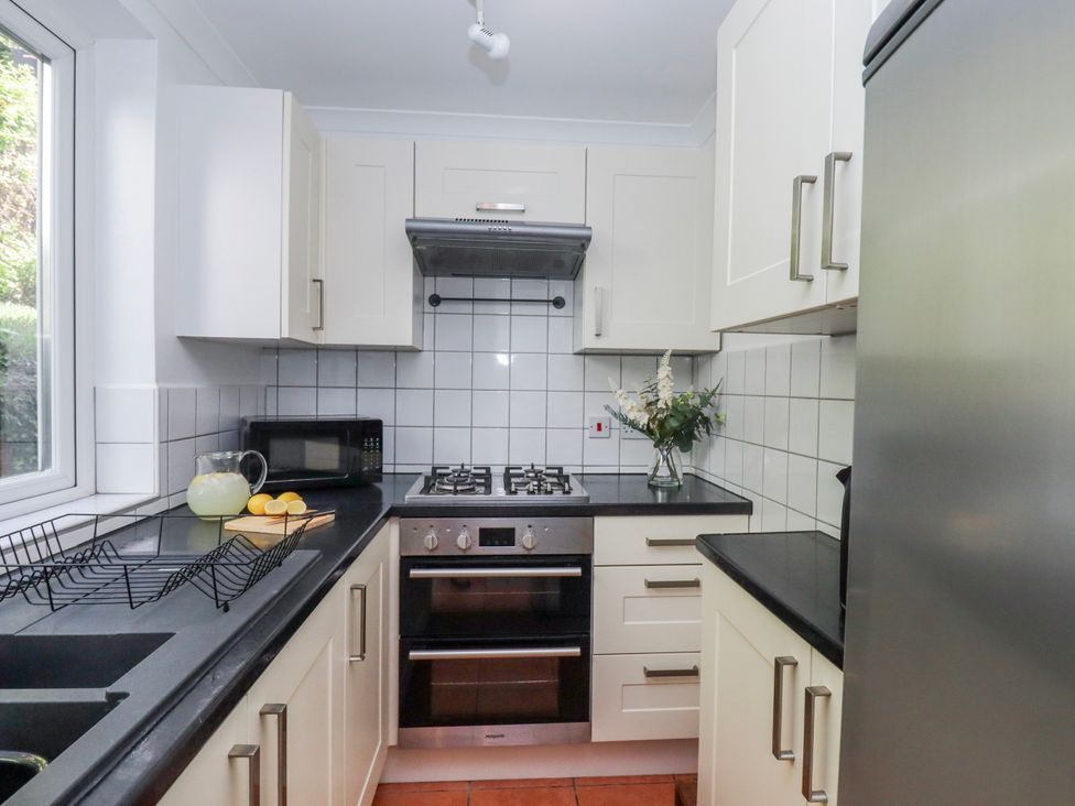 A kitchen with appliances and a sink at The Arches in Torquay