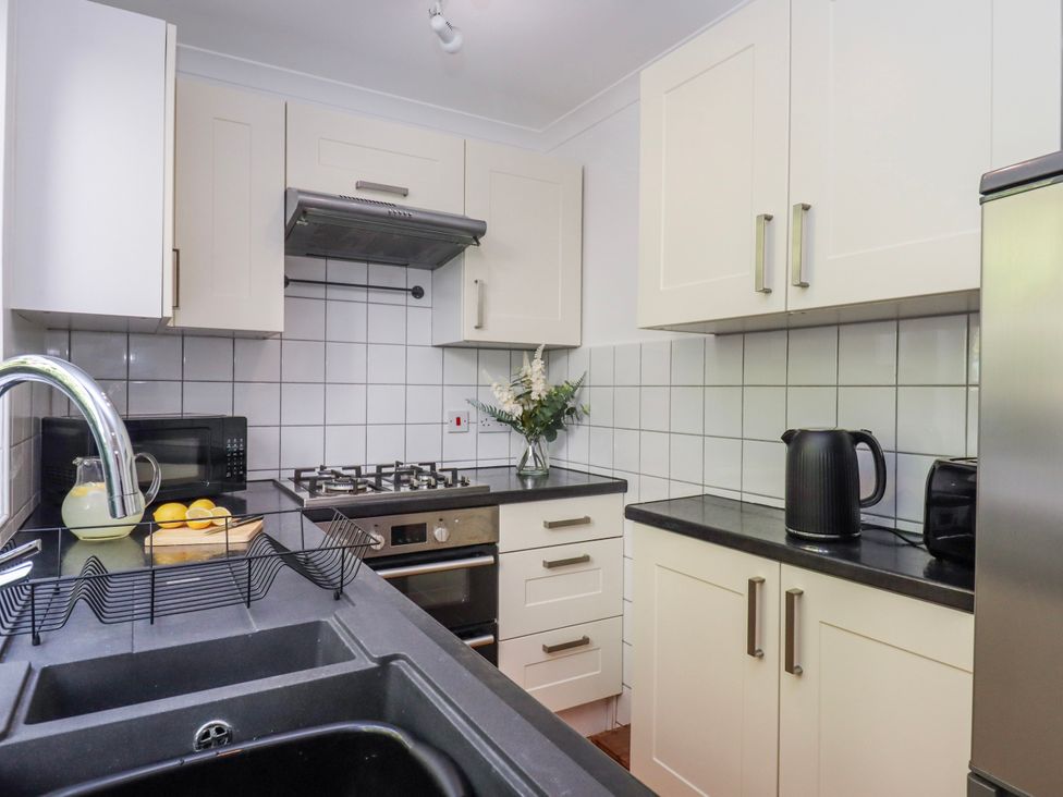 A kitchen with a stove and sink at The Arches in Torquay