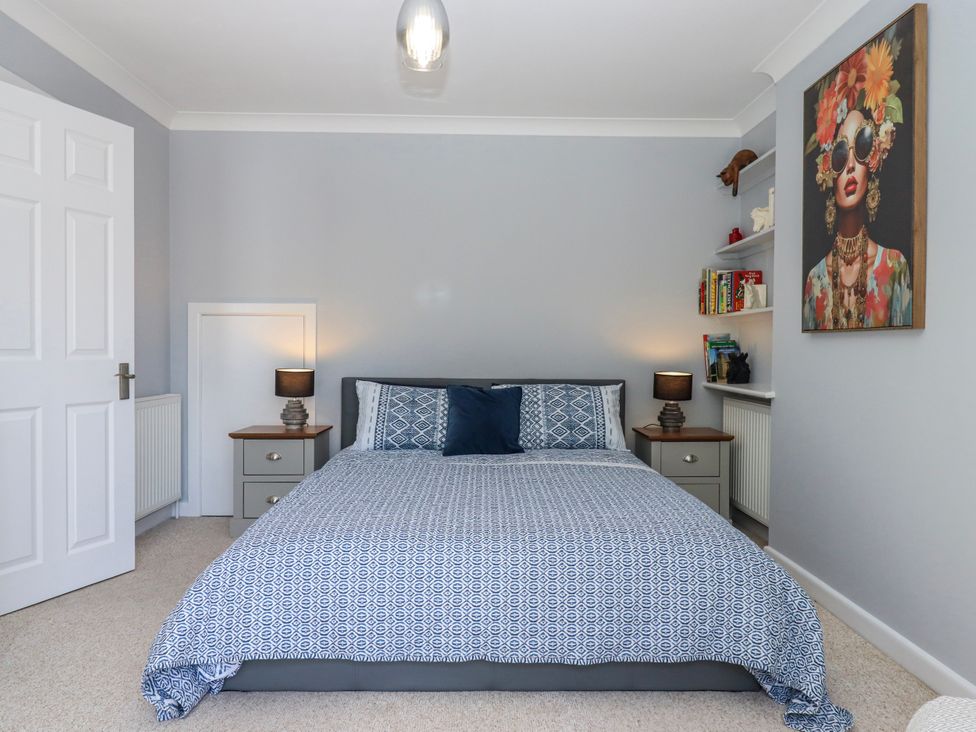A bedroom with a bed and shelf at The Arches in Torquay