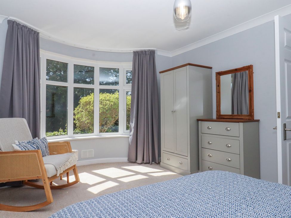 A bedroom with a bed and a wardrobe at The Arches in Torquay