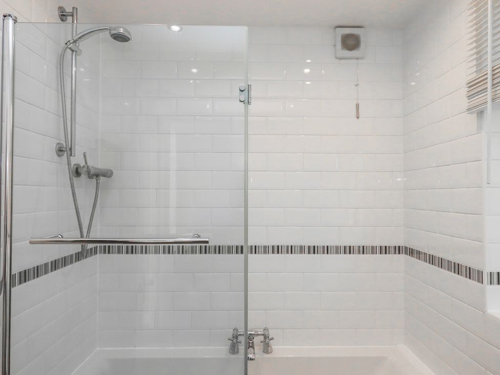 A bathroom with a shower and bathtub at The Arches in Torquay