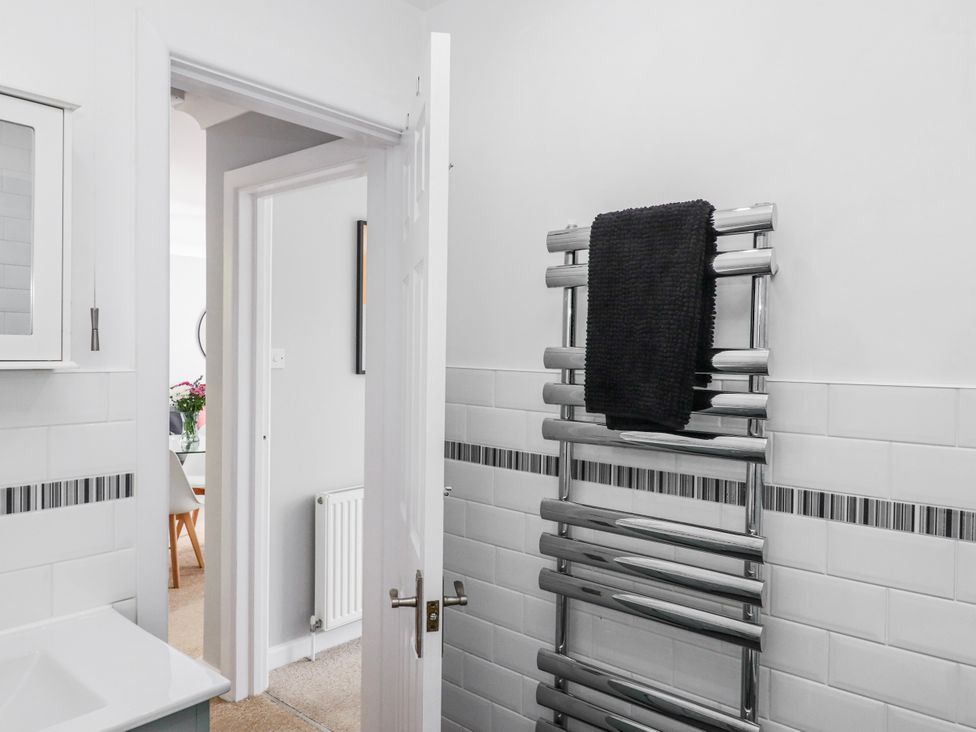 A bathroom with a towel rail and sink at The Arches in Torquay