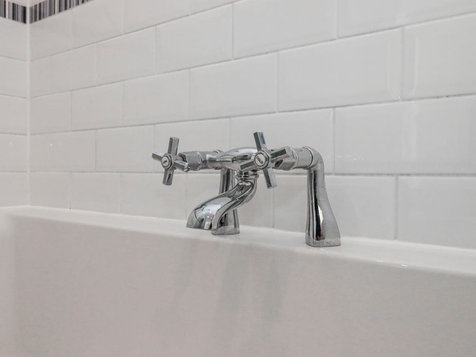 A faucet with handles above a bathtub at The Arches in Torquay