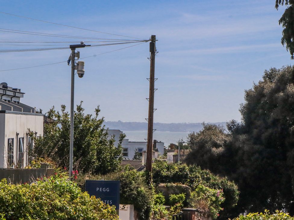 A view of the ocean and trees at The Arches in Torquay