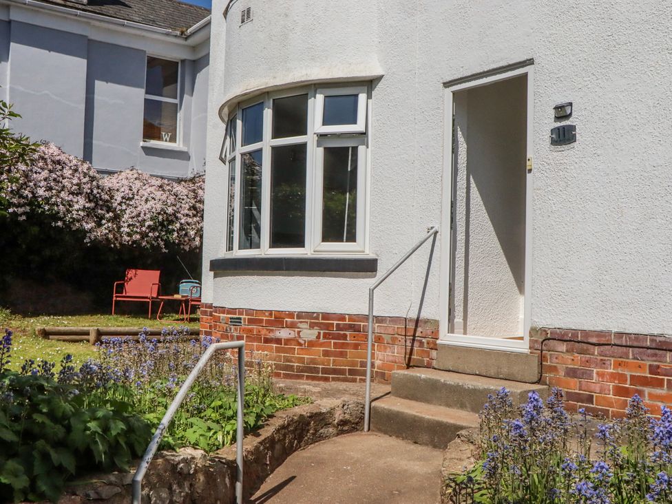 An entrance with steps and flowers at The Arches in Torquay