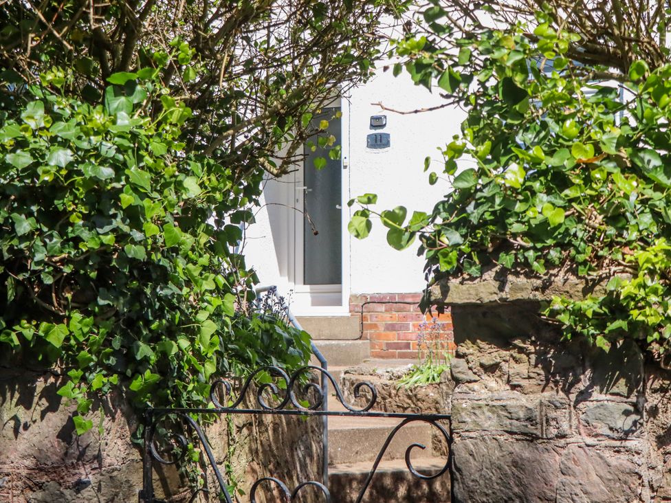 A front entrance with steps and plants at The Arches in Torquay