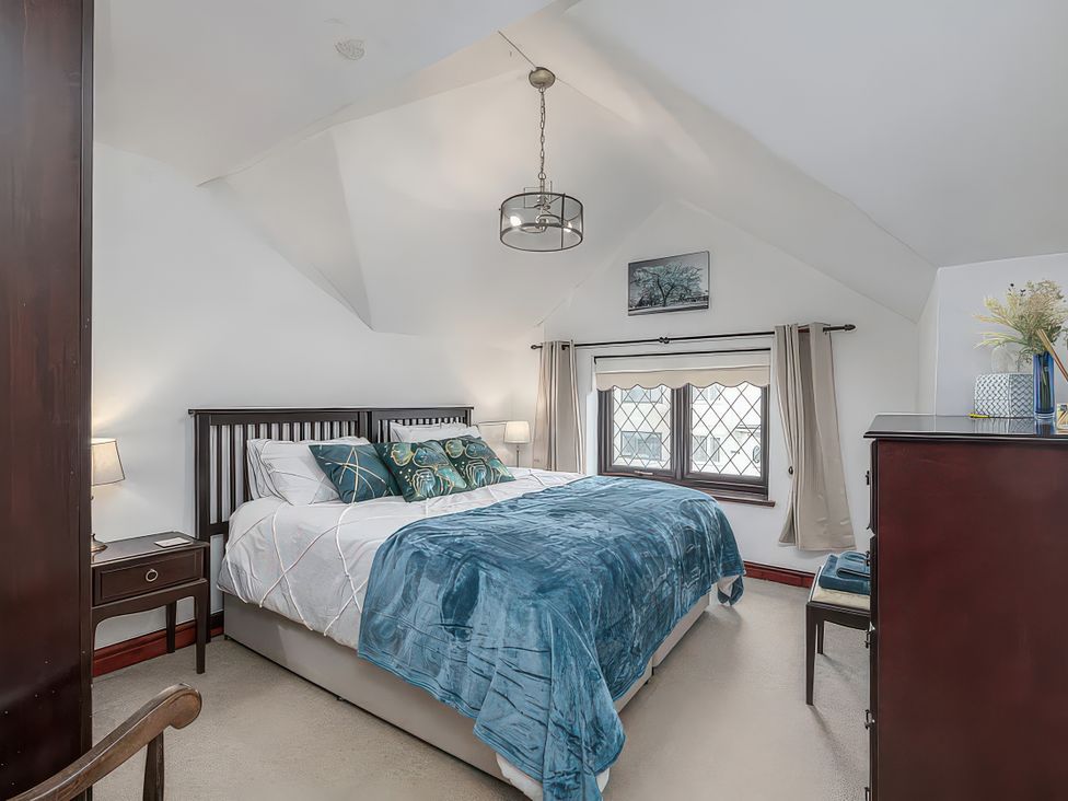 A bedroom with a bed and furniture at Preswylfa 