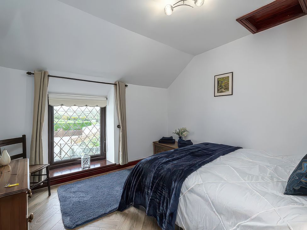 A bedroom with a bed and window at Preswylfa