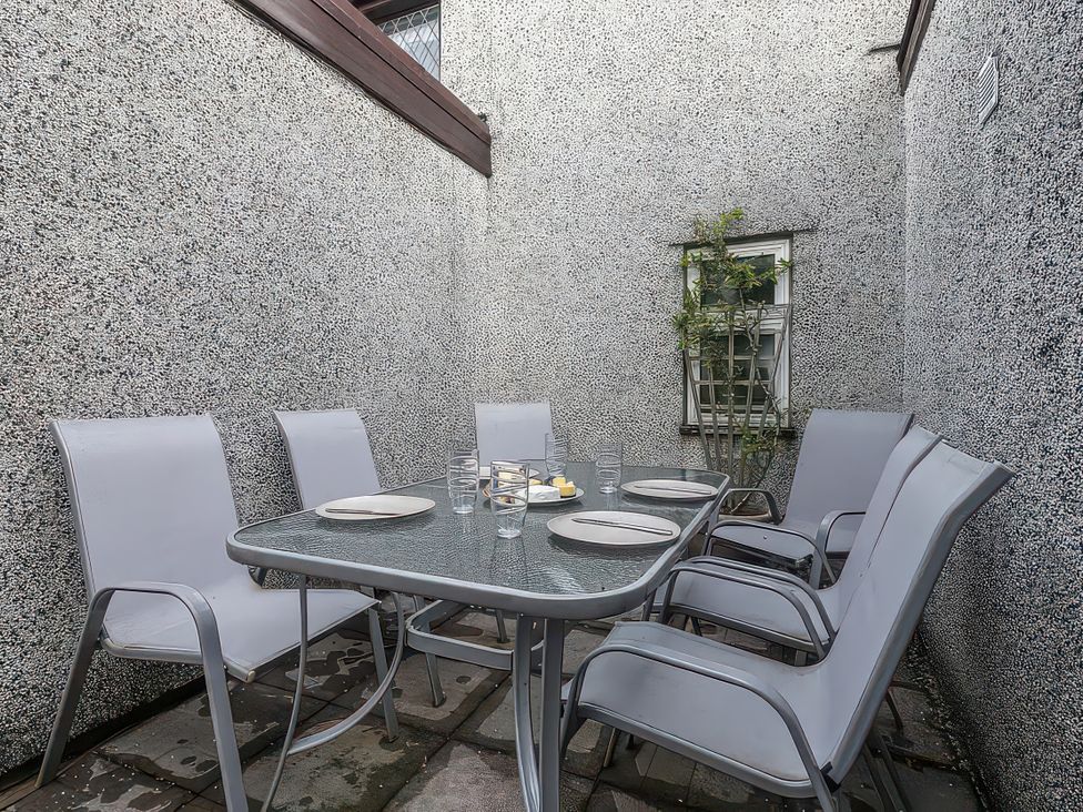 An outdoor dining area with a table and chairs at Preswylfa