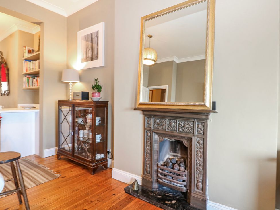 A living room with a fireplace and shelving at Broadstairs Beach in Broadstairs