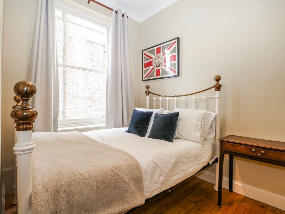 A bedroom with a bed and window at Broadstairs Beach in Broadstairs