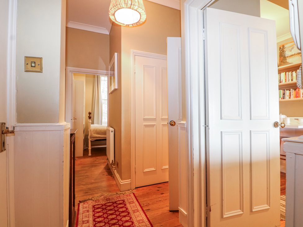 A hallway with open doors and a light fixture at Broadstairs Beach in Broadstairs