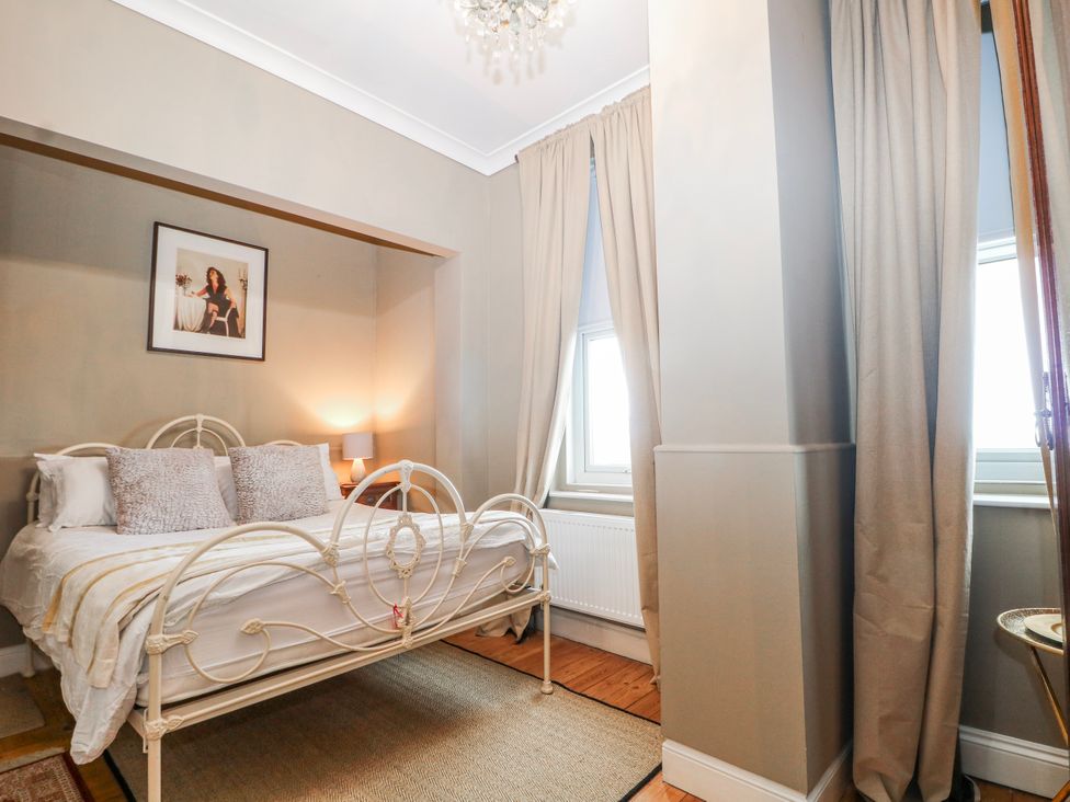 A bedroom with a bed and nightstand at Broadstairs Beach in Broadstairs