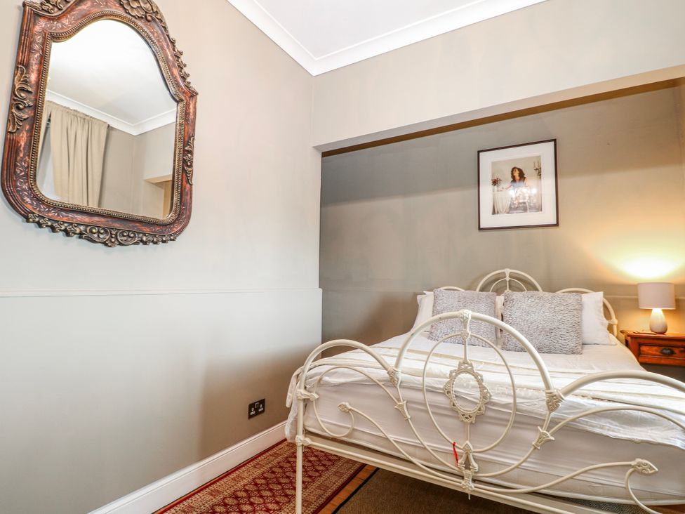 A bedroom with a bed and mirror at Broadstairs Beach in Broadstairs