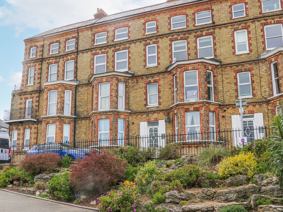 An exterior view of a building with plants and flowers at Broadstairs Beach in Broadstairs