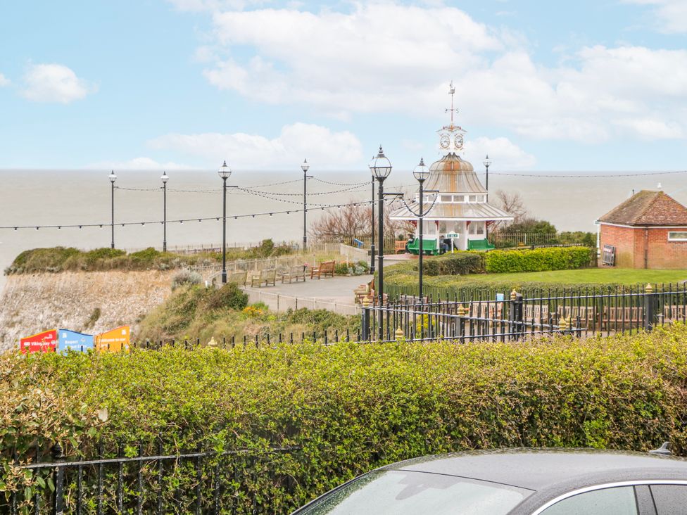 A view of a pavilion near the sea with lamp posts and benches at Broadstairs Beach in Broadstairs