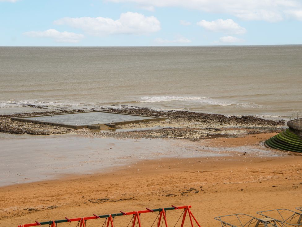 A beach with a rock pool and playground equipment at Broadstairs Beach Broadstairs